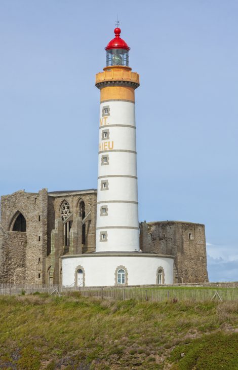 Lighthouse in front of abbey ruins at Saint-Mathieu, Brittany Ruins of abbey and lighthouse of Saint-Mathieu, Finistere, Brittany, France